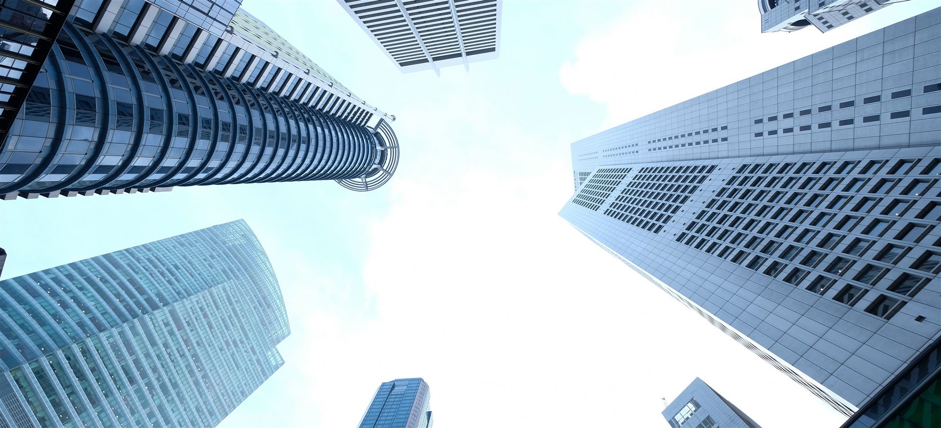 Low-angle view of downtown commercial high-rise buildings with full-height glazed facades